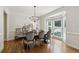 Elegant dining room with a bay window, chandelier, and hardwood flooring at 4050 Arrow Head Trl, Cumming, GA 30041