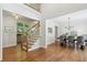 Open floor plan featuring a staircase with hardwood floors, living area, and dining room at 4050 Arrow Head Trl, Cumming, GA 30041