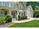 Inviting front entrance with a covered porch, lush landscaping, and stone accents at 4050 Arrow Head Trl, Cumming, GA 30041