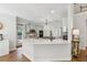 Open kitchen with a breakfast bar, modern countertops, and views of the living spaces at 4050 Arrow Head Trl, Cumming, GA 30041