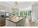Bright kitchen featuring a center island, stainless steel appliances, and modern light fixtures at 4050 Arrow Head Trl, Cumming, GA 30041