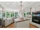 Well-lit kitchen featuring stainless steel appliances, shaker cabinets, and a functional center island at 4050 Arrow Head Trl, Cumming, GA 30041