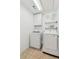 Bright laundry room with washer, dryer, and storage cabinet offers convenience and efficiency at 4050 Arrow Head Trl, Cumming, GA 30041