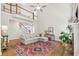 Spacious living room with a fireplace and high ceiling, showcasing the open floor plan and natural light at 4050 Arrow Head Trl, Cumming, GA 30041