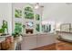 Bright living room featuring a fireplace, soaring windows, and hardwood floors, creating a cozy and inviting atmosphere at 4050 Arrow Head Trl, Cumming, GA 30041