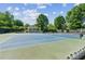 Outdoor blue and green tennis court surrounded by lush greenery and a gazebo at 4050 Arrow Head Trl, Cumming, GA 30041