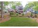 Expansive backyard with a well-manicured lawn, fire pit, and access to the home's elevated deck at 79 Anniston Se Ave, Atlanta, GA 30317
