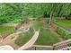 Aerial view of a spacious backyard with a stone pathway, fire pit, and lush greenery at 79 Anniston Se Ave, Atlanta, GA 30317