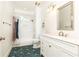 Bathroom with white vanity, updated hardware, a shower-tub combination and blue patterned tile floor at 79 Anniston Se Ave, Atlanta, GA 30317