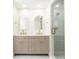 Elegant bathroom featuring a double vanity, marble countertops, and a glass-enclosed shower at 79 Anniston Se Ave, Atlanta, GA 30317