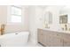 Elegant bathroom features a soaking tub, double vanity, and modern fixtures at 79 Anniston Se Ave, Atlanta, GA 30317