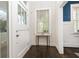 Bright entryway features dark hardwood floors, white trim, and a charming accent table beneath a window at 79 Anniston Se Ave, Atlanta, GA 30317
