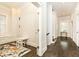 Hallway with playroom and staircase featuring hardwood floors, white trim, and natural light at 79 Anniston Se Ave, Atlanta, GA 30317
