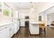 Bright kitchen features white cabinets, marble countertops, a center island, and stainless steel appliances at 79 Anniston Se Ave, Atlanta, GA 30317