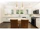 Bright kitchen featuring white cabinets, stainless steel appliances, and a marble countertop island at 79 Anniston Se Ave, Atlanta, GA 30317