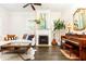 Spacious living room with fireplace, piano, and stylish decor for entertaining at 79 Anniston Se Ave, Atlanta, GA 30317