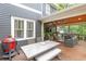 Outdoor porch with dining area, grill, ceiling fan, and comfortable seating, perfect for entertaining at 79 Anniston Se Ave, Atlanta, GA 30317