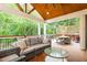 Relaxing covered back porch with comfortable seating, a dining table, and a grill at 79 Anniston Se Ave, Atlanta, GA 30317