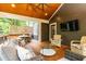 Open porch featuring comfortable seating, wooden flooring, a ceiling fan, and an outdoor television at 79 Anniston Se Ave, Atlanta, GA 30317