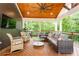 Spacious screened-in porch featuring comfortable seating, ceiling fan, wood floor, and an outdoor television at 79 Anniston Se Ave, Atlanta, GA 30317