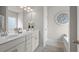 Bright bathroom with double vanity sinks, white cabinets, and modern fixtures at 1245 Elowen Dr, Austell, GA 30168