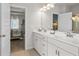 Bathroom with double vanity, open doorway to Main Bedroom, and tiled floor at 1245 Elowen Dr, Austell, GA 30168