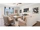 Cozy living room with plush seating, a large TV, and natural light from the windows at 1245 Elowen Dr, Austell, GA 30168