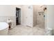 Elegant bathroom featuring marble tile, a modern shower, and a freestanding tub at 2798 Glenlocke Nw Cir, Atlanta, GA 30318
