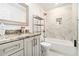 Bathroom with tub and shower combo, marble tiling, and granite countertops at 2798 Glenlocke Nw Cir, Atlanta, GA 30318