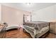 Bedroom with hardwood floors, neutral colors, and a grey chaise lounge seating area at 2798 Glenlocke Nw Cir, Atlanta, GA 30318