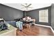 Spacious bedroom with hardwood floors, a window with lots of natural light, and a ceiling fan at 2798 Glenlocke Nw Cir, Atlanta, GA 30318
