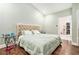Bright bedroom with tufted headboard, modern accents, and an en-suite closet offering ample storage space at 2798 Glenlocke Nw Cir, Atlanta, GA 30318