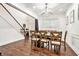 Bright dining room with hardwood floors, a modern light fixture, and staircase view at 2798 Glenlocke Nw Cir, Atlanta, GA 30318