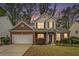 Charming two-story home with an attached garage and well-maintained landscaping at 2798 Glenlocke Nw Cir, Atlanta, GA 30318