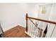 Bright staircase with hardwood floors, white banisters, and views of the entry at 2798 Glenlocke Nw Cir, Atlanta, GA 30318