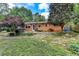 Spacious backyard with patio area, brick house exterior, and mature trees at 3081 Anthony Dr, Decatur, GA 30033