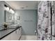 Well-lit bathroom with modern fixtures, decorative shower curtain, and ample counter space at 3081 Anthony Dr, Decatur, GA 30033