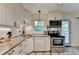 Well-lit kitchen with white cabinets, granite countertops, stainless steel appliances, and tile backsplash at 3081 Anthony Dr, Decatur, GA 30033