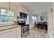Well-lit kitchen with white cabinets, granite countertops, stainless steel appliances, and tile backsplash at 3081 Anthony Dr, Decatur, GA 30033