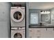Efficient laundry area with stacked Samsung washer and dryer, and a modern vanity with vessel sink at 3081 Anthony Dr, Decatur, GA 30033