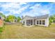 Landscaped backyard featuring a screened-in porch perfect for outdoor relaxation at 463 Marston Pass, Acworth, GA 30102