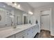 Modern bathroom with dual sinks, quartz countertops, white cabinetry, and glass enclosed shower at 463 Marston Pass, Acworth, GA 30102