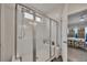 Modern bathroom featuring a glass-enclosed shower with white subway tile and a view into the bedroom at 463 Marston Pass, Acworth, GA 30102
