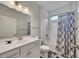Clean bathroom with a single vanity, toilet, and shower-tub combo with stylish shower curtain at 463 Marston Pass, Acworth, GA 30102
