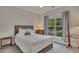 Cozy bedroom with a large window allowing natural light and neutral-toned furnishings at 463 Marston Pass, Acworth, GA 30102