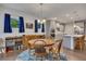 Bright dining area with hardwood floors, a round wooden table, and adjacent kitchen with stainless steel appliances at 463 Marston Pass, Acworth, GA 30102
