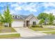 Charming home featuring a two-car garage, stone accents, dormers, and a well-manicured lawn at 463 Marston Pass, Acworth, GA 30102