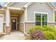 Close up of the exterior featuring a dark brown front door with a beige stone and siding facade at 463 Marston Pass, Acworth, GA 30102