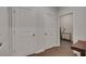 Hallway with gray walls, white doors, and wood floors leads to a laundry room at 463 Marston Pass, Acworth, GA 30102