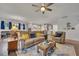 Open-concept living area with hardwood floors, a comfortable sofa, and access to the kitchen and dining space at 463 Marston Pass, Acworth, GA 30102